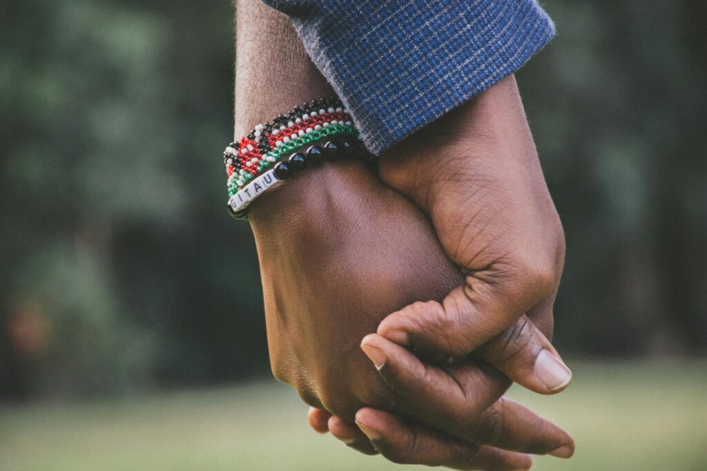 close up photo of two people holding hands