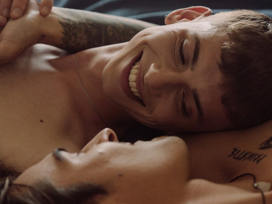 a male couple lying on bed